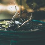 Water container that has water splashed up on a blurred background.