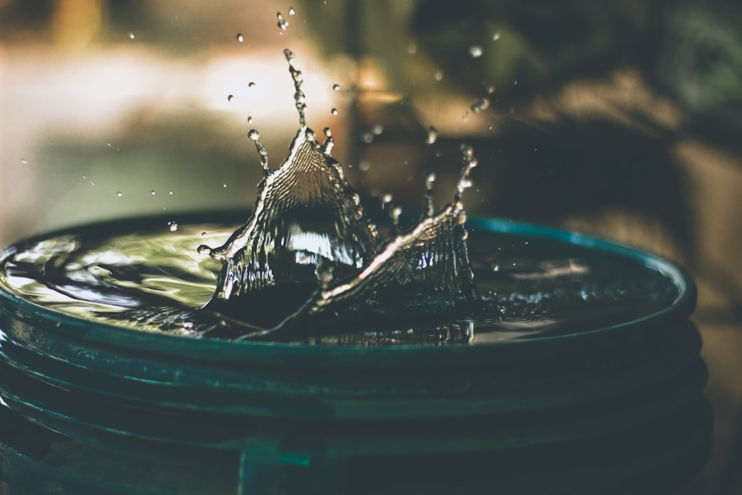 Water container that has water splashed up on a blurred background.